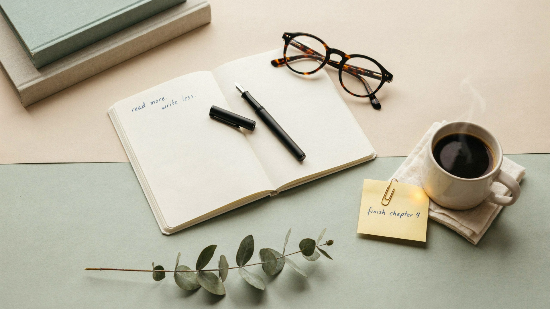 Study aesthetic 2K Quad HD PC desktop wallpaper and background: open notebook with pen, eyeglasses, coffee cup, sticky note and eucalyptus on a pale desk.