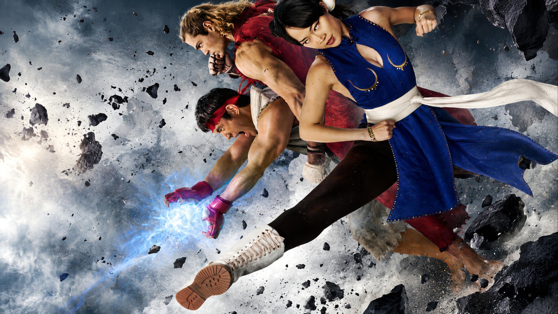 Dynamic 4K Ultra HD PC desktop wallpaper background featuring Street Fighter (2026): three fighters, a blond, a red-band warrior and a blue-clad combatant, midair kicks amid flying debris.