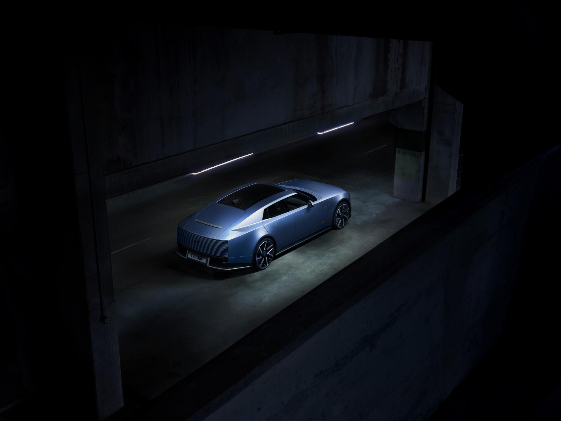 Jaguar Type 01 blue sports car in a dark showroom, 8K Ultra HD PC desktop wallpaper and background.