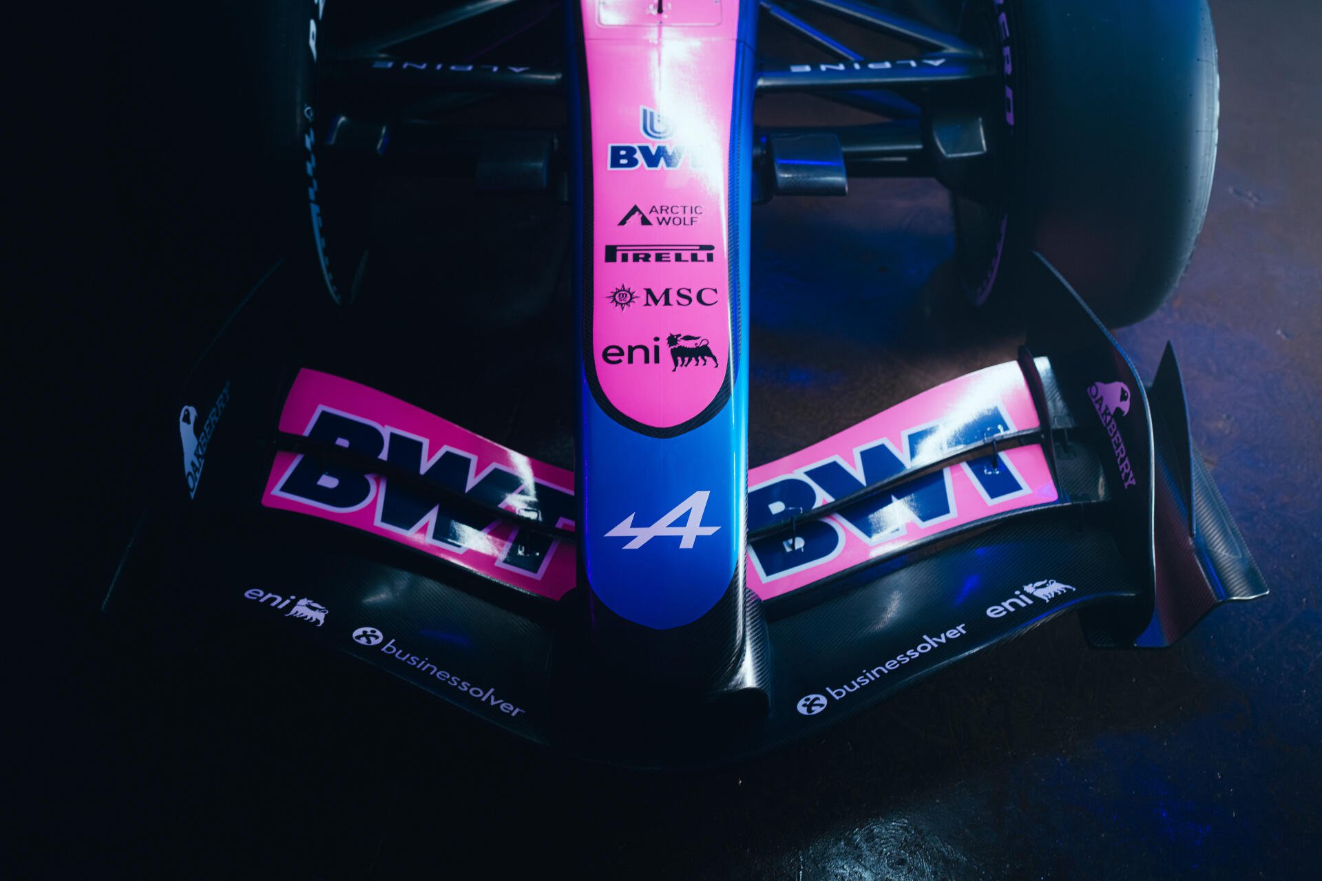 Alpine A526 Formula 1 race car in dramatic blue lighting, featuring BWT branding, in an 8K Ultra HD desktop wallpaper.