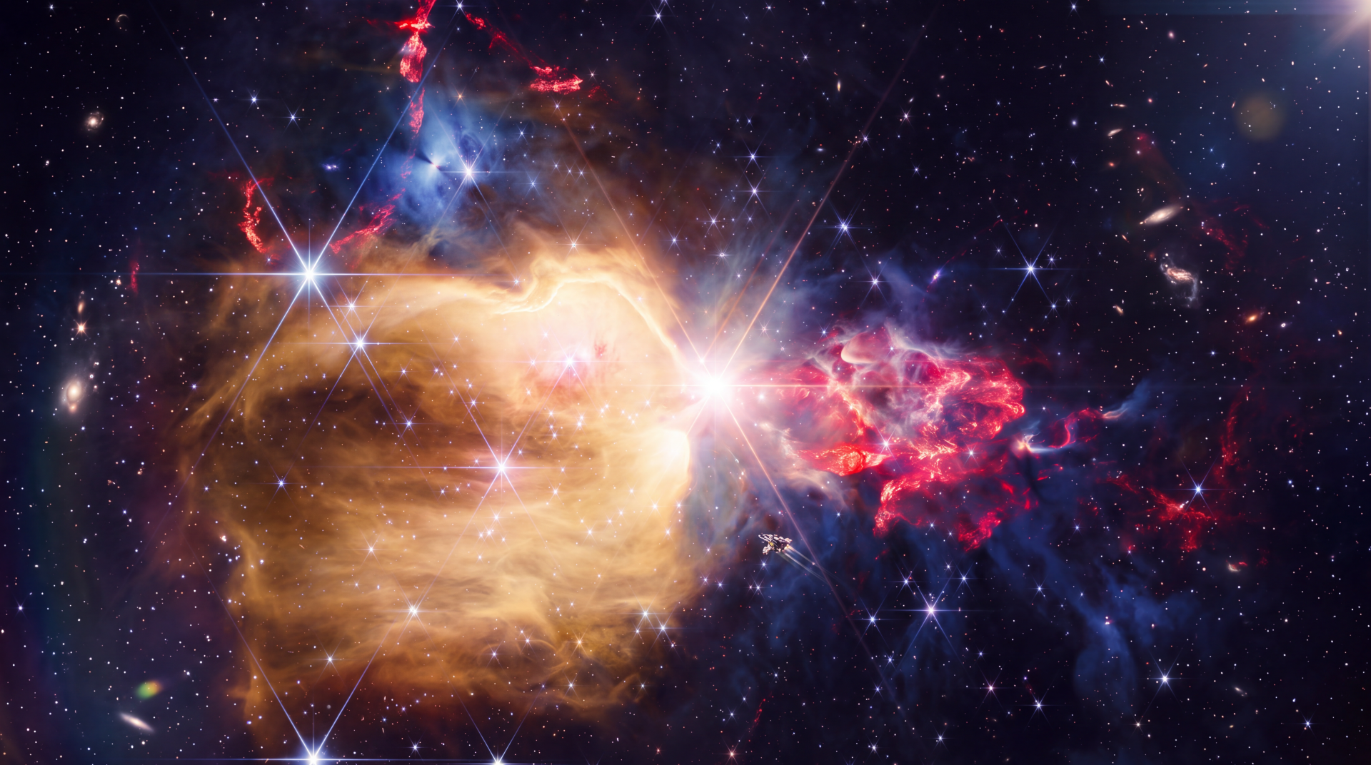 NASA James Webb Space Telescope view of NGC 7129, a glowing gold and red nebula among stars, in 5K Ultra HD desktop wallpaper.