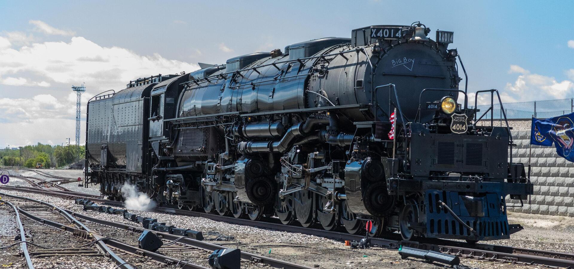 Union Pacific Big Boy 4014 steam locomotive on railroad tracks, featured in a HD PC desktop wallpaper and background.