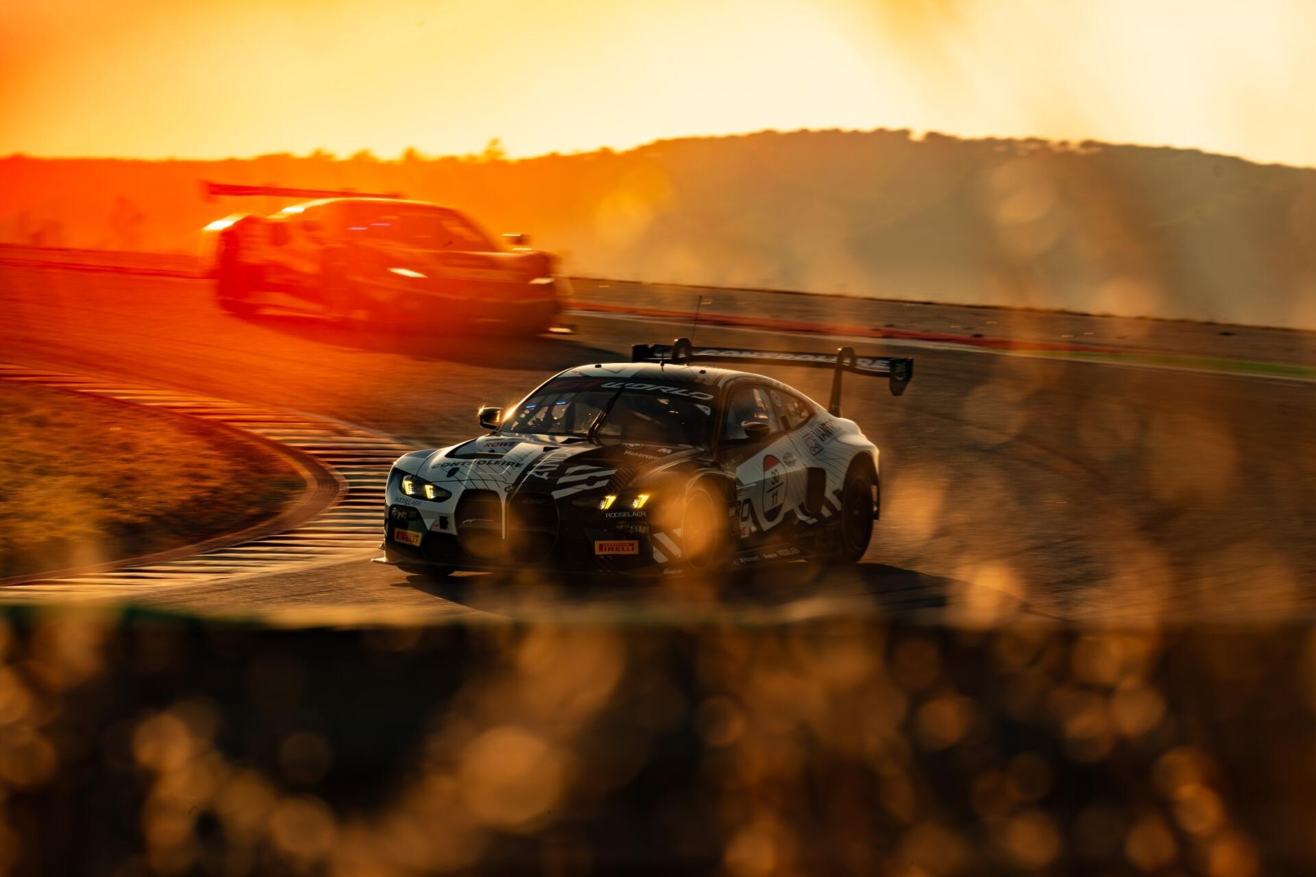 BMW M4 GT3 race car drifting through a sunlit track, with dust and motion blur in a dramatic HD desktop wallpaper.
