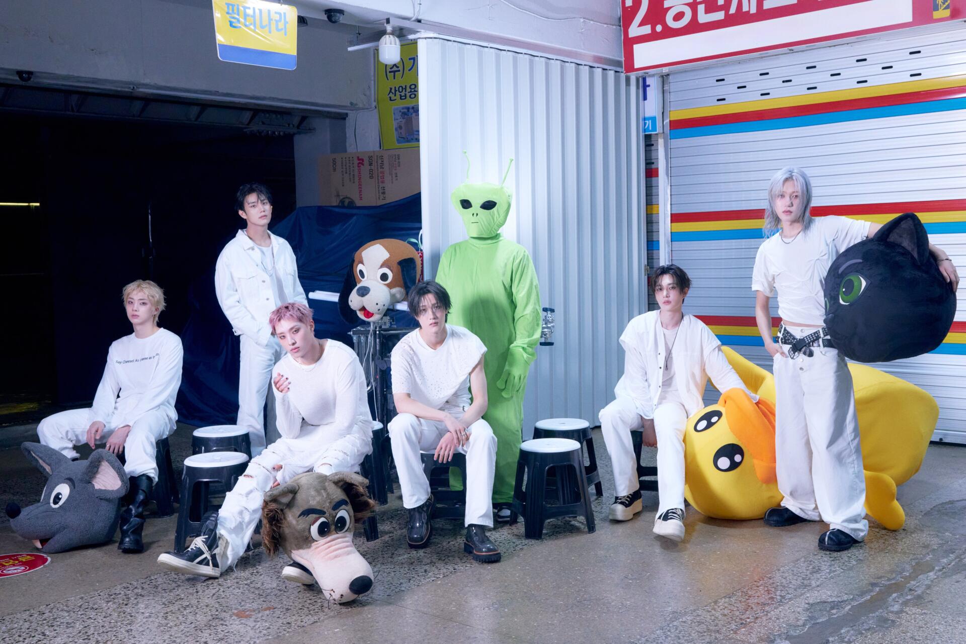 P1Harmony pose with a green alien-costumed figure and colorful props on the BLOW UP set, 4K Ultra HD desktop wallpaper.