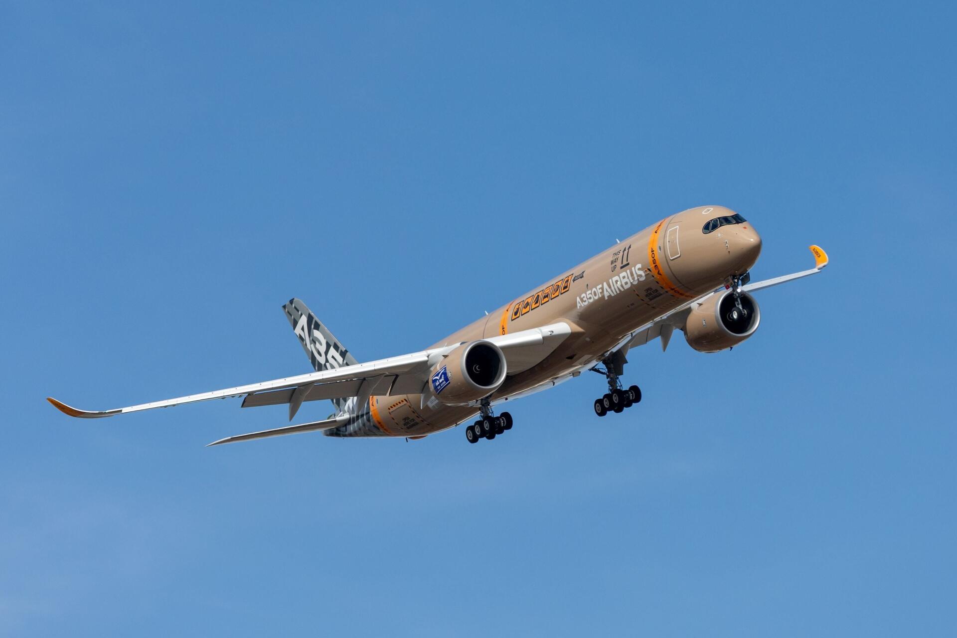 Airbus A350F airplane climbing through a clear blue sky, featured in a 2K Quad HD PC desktop wallpaper and background.