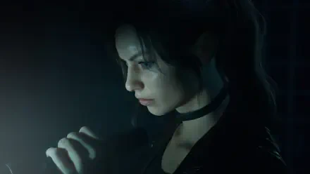 Close-up of a character from Resident Evil: Code Veronica, lit by a small handheld light in a dark scene — 4K Ultra HD PC desktop wallpaper and background.