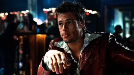 Smirking man in a red leather jacket leans on a dim bar counter; moody Fight Club 4K Ultra HD PC desktop wallpaper and background.