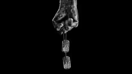 Grimy fist clutching dog tags against a black backdrop — Rambo HD PC desktop wallpaper and background