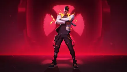 HD PC desktop wallpaper: Phoenix from Valorant stands with arms crossed amid fiery effects, framed by a glowing red background.