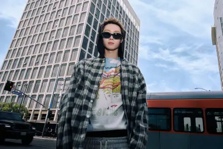 Cortis Color Outside the Lines — fashion portrait of a woman in sunglasses and a plaid jacket against a cityscape and bus; 4K Ultra HD PC desktop wallpaper/background.