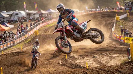Airborne dirt bike racer on a dusty motocross track, captured in 5K Ultra HD PC desktop wallpaper and background.