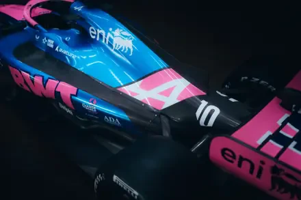 Alpine A526 F1 race car in blue and pink livery, featured in an 8K Ultra HD desktop wallpaper background.