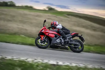 BMW F 450 RR sportbike and motorcyclist racing along a country road, featured in an 8K Ultra HD desktop wallpaper and background.