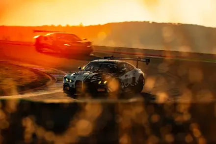 BMW M4 GT3 race car drifting through a sunlit track, with dust and motion blur in a dramatic HD desktop wallpaper.