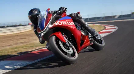 Honda CBR500R Four racing motorcycle leaning into a racetrack turn, 5K Ultra HD PC desktop wallpaper and background.