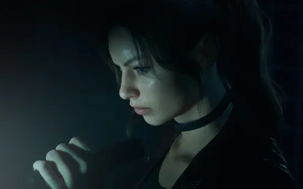Close-up of a character from Resident Evil: Code Veronica, lit by a small handheld light in a dark scene — 4K Ultra HD PC desktop wallpaper and background.
