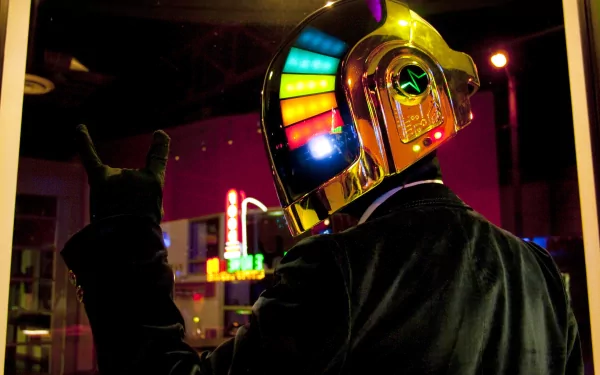 HD PC wallpaper featuring a neon-lit Daft Punk robot in a nightlife setting, with vibrant colorful lights on the helmet and a dark urban backdrop.
