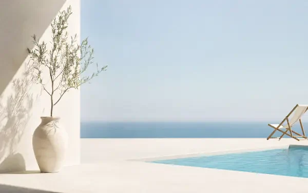 Minimalist summer 4K Ultra HD PC desktop wallpaper and background: sunlit white terrace with vase and olive branch, pool edge, lounge chair overlooking calm blue sea.