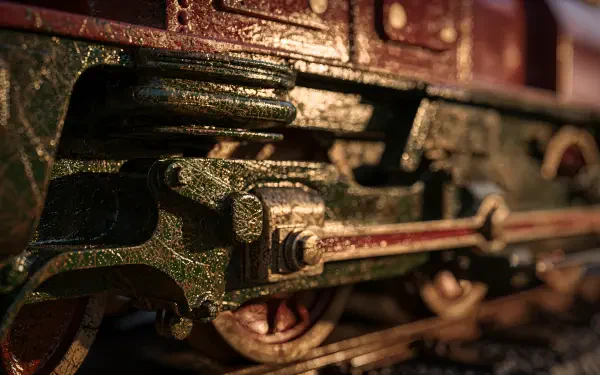 Close-up of a weathered green locomotive's wheel and connecting rods, textured metal detail — 4K Ultra HD PC desktop wallpaper and background.