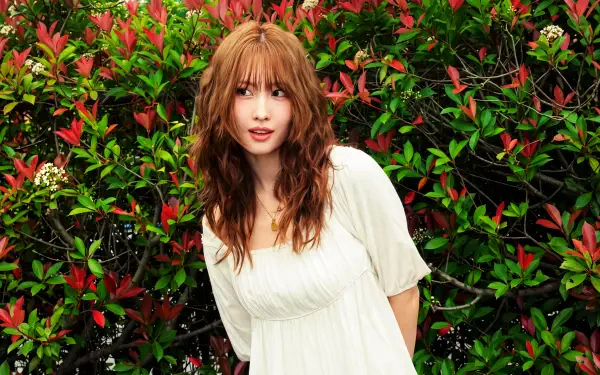Young woman in a white dress framed by red-green foliage, K-pop/Japanese model aesthetic, 5K Ultra HD PC desktop wallpaper background.
