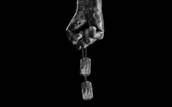 Grimy fist clutching dog tags against a black backdrop — Rambo HD PC desktop wallpaper and background