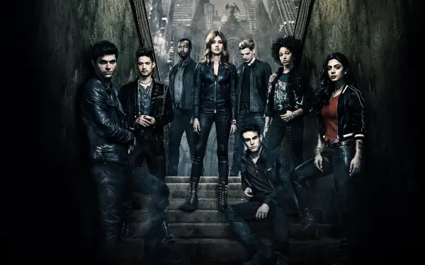 Ensemble of Shadowhunters characters in leather jackets posed on stone steps in a dark, misty gothic alley, moody lighting — 4K Ultra HD PC desktop wallpaper/background.