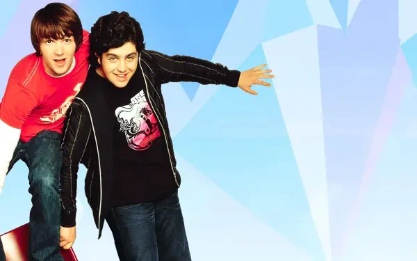 HD PC desktop wallpaper showing two smiling teen sitcom co-stars leaning forward against a pale blue, faceted geometric background.