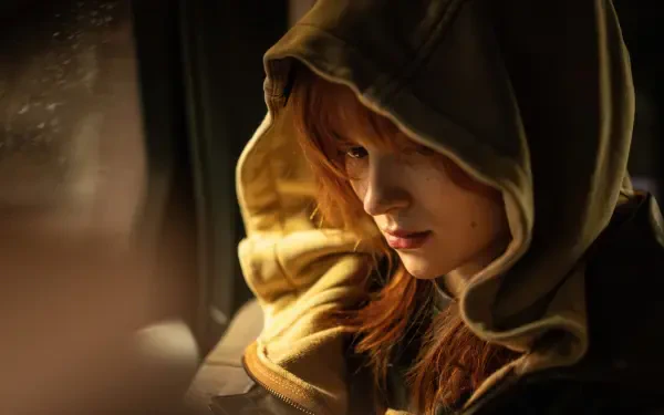 Close-up of a red-haired woman in a hooded jacket, warm cinematic light and pensive expression — Spider-Man: Brand New Day 4K Ultra HD PC Desktop Wallpaper and Background.
