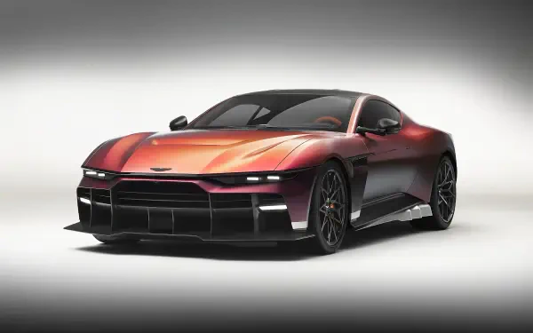 Aston Martin Valen sports car coupé in metallic red, three-quarter front view on a neutral studio backdrop, presented as an 8K Ultra HD PC desktop wallpaper and background.
