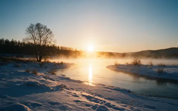 4K Ultra HD PC desktop wallpaper and background: winter sunrise over a snowy river landscape, golden sun and mist reflecting on calm water, bare trees and low hills.