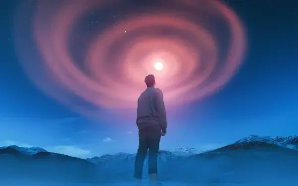 5K Ultra HD PC desktop wallpaper background: a lone man stands beneath a glowing spiral of light in the sky, framed by misty mountains and a luminous, otherworldly glow.