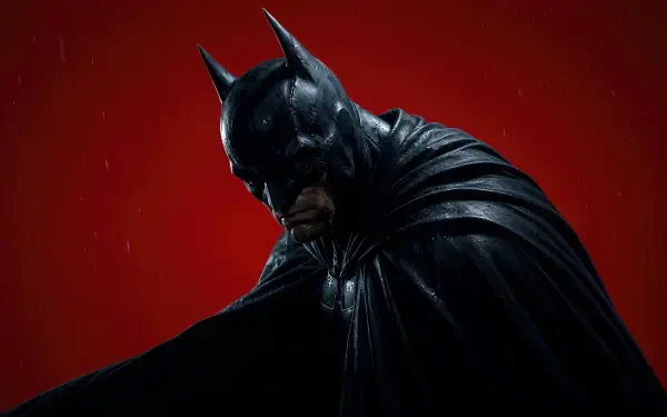 4K Ultra HD digital art PC wallpaper: Batman in a black cowl and flowing cape, rain-slicked, brooding against a stark red background.
