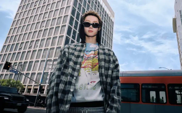 Cortis Color Outside the Lines — fashion portrait of a woman in sunglasses and a plaid jacket against a cityscape and bus; 4K Ultra HD PC desktop wallpaper/background.