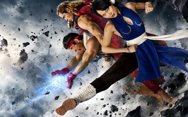 Dynamic 4K Ultra HD PC desktop wallpaper background featuring Street Fighter (2026): three fighters, a blond, a red-band warrior and a blue-clad combatant, midair kicks amid flying debris.