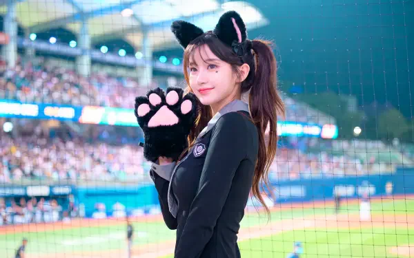 5K Ultra HD desktop wallpaper of a cat-girl cheerleader in a school uniform, wearing cat ears and paw gloves, smiling at a baseball stadium crowd.
