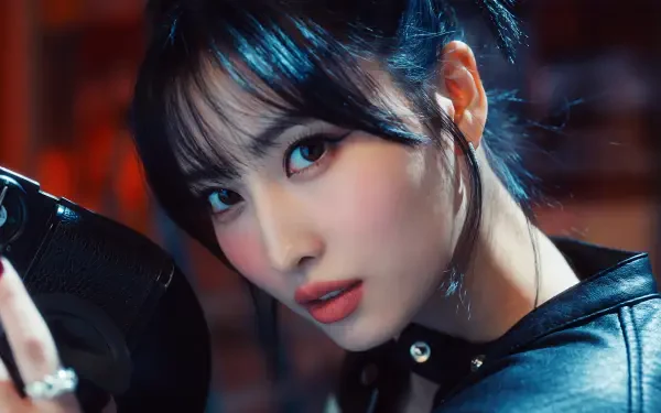 Close-up studio portrait of a young woman with dark bangs and leather jacket, dramatic makeup and dangling earring, vibrant 5K Ultra HD K-pop style desktop wallpaper.