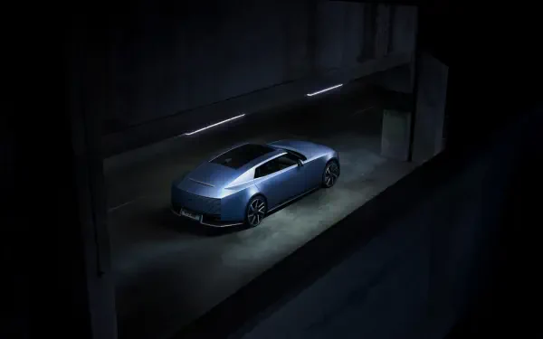 Jaguar Type 01 blue sports car in a dark showroom, 8K Ultra HD PC desktop wallpaper and background.