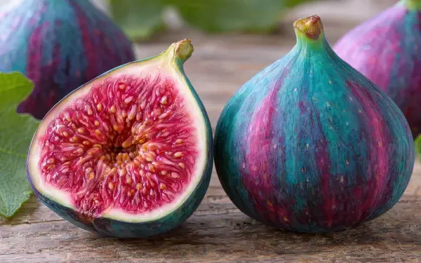 Fresh whole and sliced figs with vivid red centers, featured in a 4K Ultra HD PC desktop wallpaper and background.