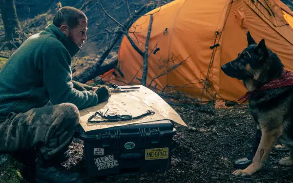 Brad Pitt camping beside an orange tent with a dog in Heart of the Beast HD desktop wallpaper background.