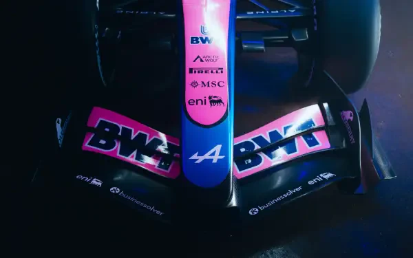 Alpine A526 Formula 1 race car in dramatic blue lighting, featuring BWT branding, in an 8K Ultra HD desktop wallpaper.