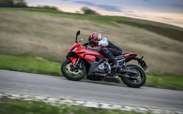 BMW F 450 RR sportbike and motorcyclist racing along a country road, featured in an 8K Ultra HD desktop wallpaper and background.