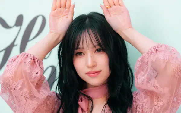 TWICE and MiSaMo member Mina, Japanese model and K-pop idol, poses in a pink blouse in this 5K Ultra HD desktop wallpaper.