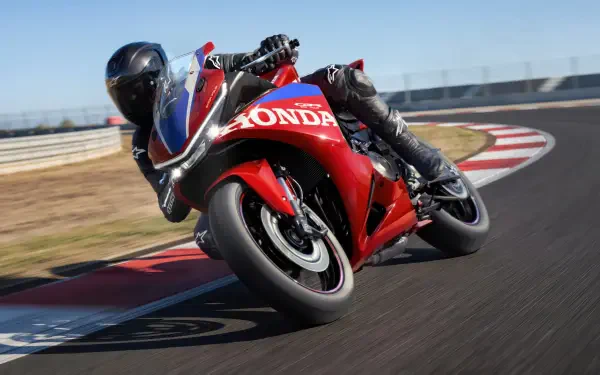 Honda CBR500R Four racing motorcycle leaning into a racetrack turn, 5K Ultra HD PC desktop wallpaper and background.