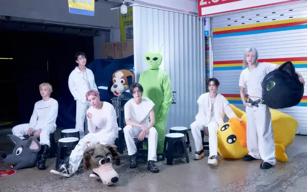 P1Harmony pose with a green alien-costumed figure and colorful props on the BLOW UP set, 4K Ultra HD desktop wallpaper.