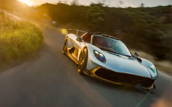 Aston Martin Valhalla Spider supercar on a forest road at golden hour, 8K Ultra HD PC desktop wallpaper and background.