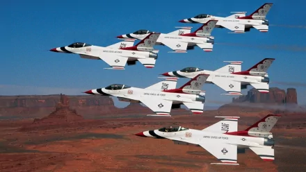 Military fighter jets in tight air-show formation over a desert canyon — HD PC desktop wallpaper and background.