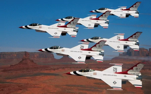 Military fighter jets in tight air-show formation over a desert canyon — HD PC desktop wallpaper and background.