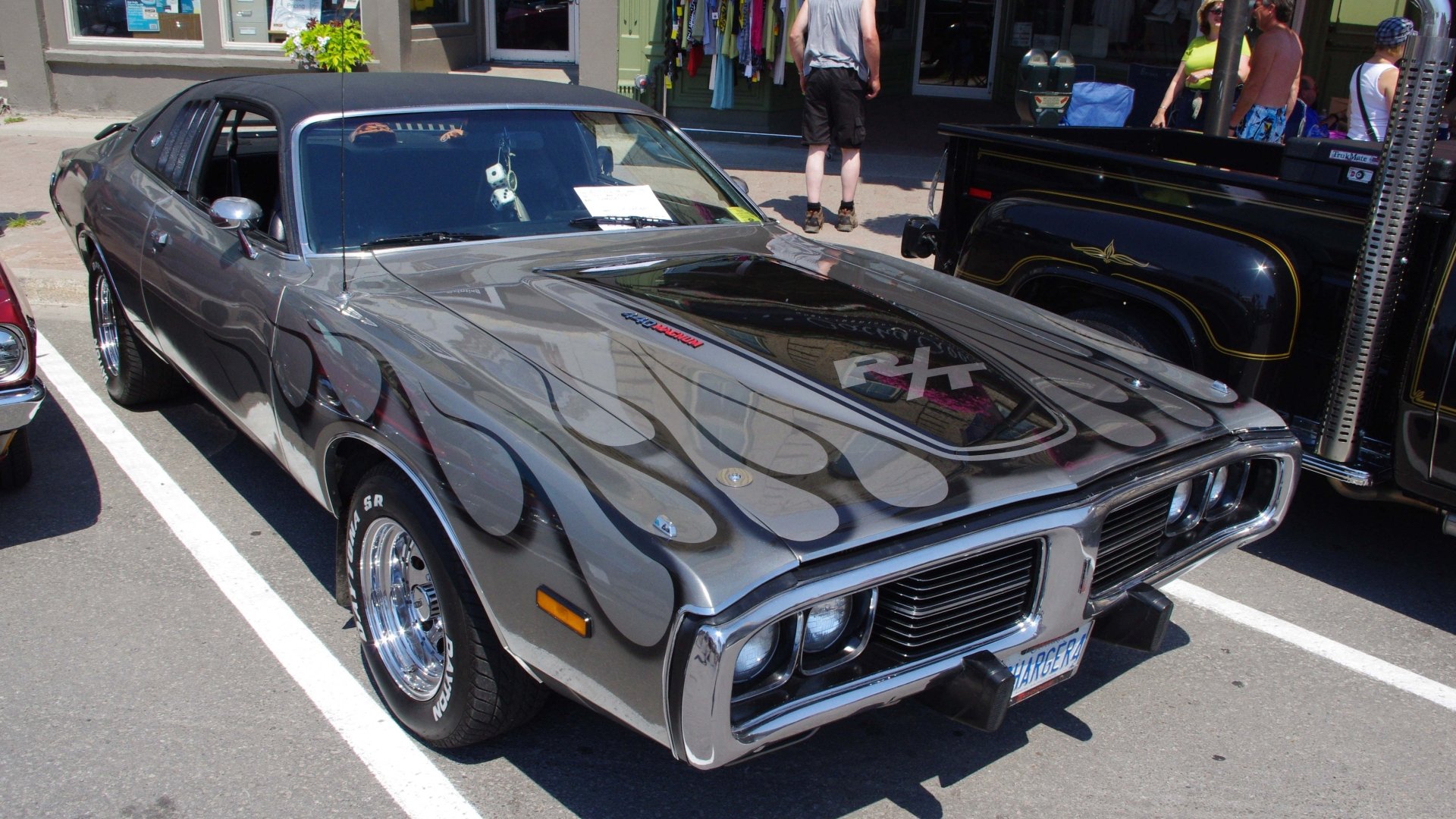 HD PC desktop wallpaper featuring a Dodge vehicle with custom flame detailing parked outdoors at a car show.