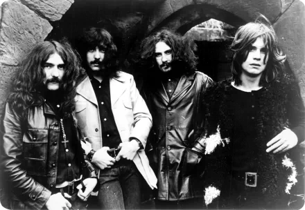Black and white HD desktop wallpaper of the heavy metal band Black Sabbath featuring Ozzy Osbourne and band members in 1970s attire.