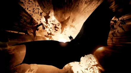 HD desktop wallpaper featuring a dramatic scene from the movie Batman Begins, showcasing Batman silhouetted against a backdrop of bats.